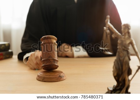 justice and law concept. Male judge take judge hammer and judge the case in a courtroom. Royalty-Free Stock Photo #785480371