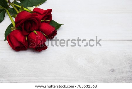 Bouquet of red  roses on a old wooden background