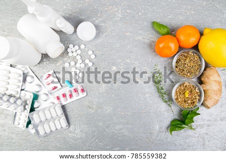 Alternative remedies and traditional pills to treat colds and flu. Natural medicine vs conventional medicine concept. Copy space. Royalty-Free Stock Photo #785559382