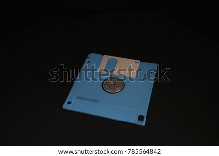 A colorful floppy disk on the black background