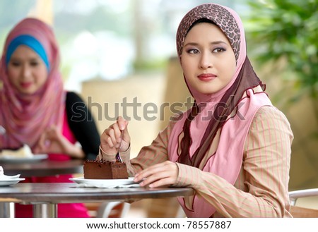 Beautiful Muslim women having lunch at coffee shop