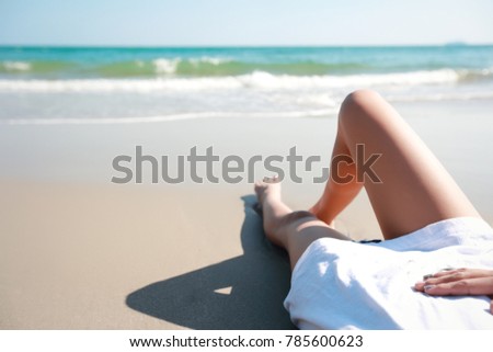 portrait of beautiful woman top view lying on sandy and looking to the sea (this image for holiday vacation concept)
