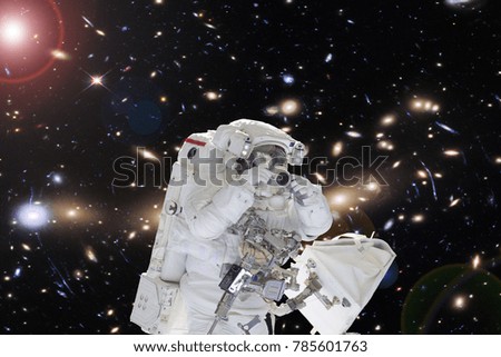 Astronaut with a camera. Science theme. The elements of this image furnished by NASA.