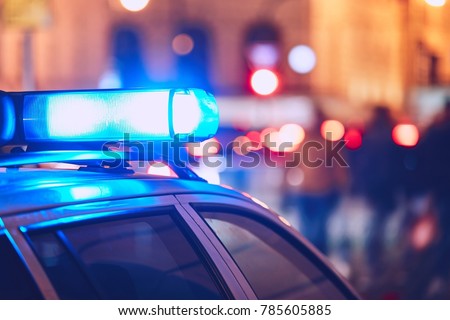 Danger on the street. Blue flasher on the police car at night. Royalty-Free Stock Photo #785605885