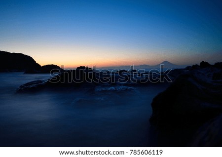 Mt. Fuji silhouette with reef at sunset slow shutter