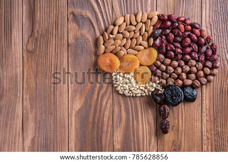 Human brain is made of dried apricots and nuts on a wooden table.   Concept of healthy food.  Royalty-Free Stock Photo #785628856