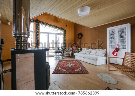 cozy decorated interior, big bright windows and glass door, fire place and xmas decor.