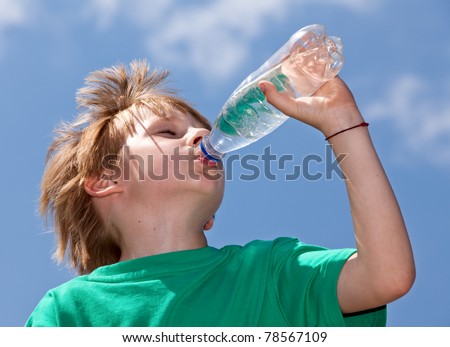 Thirsty boy drinking fresh water outdoors Royalty-Free Stock Photo #78567109