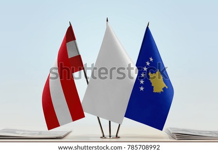 Flags of Austria and Kosovo with a white flag in the middle