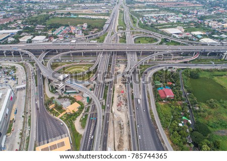 Aerial day view of traffic junction cross road with car transport