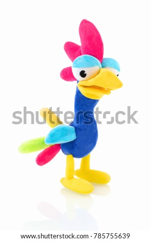 Chicken plushie doll isolated on white background with shadow reflection. Rooster plush stuffed puppet on white backdrop. Cute rainbow colored stuffed bird toy.