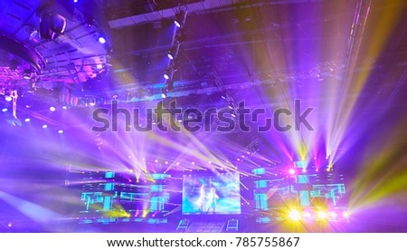 Colored foggy projector lights during performance