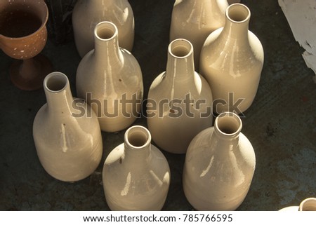 Batch of traditional handmade bottle design from raw ceramic material