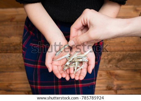 Parent child hand with boiled sardine