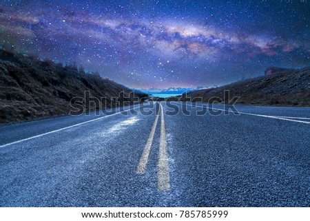Straight empty highway with milkyway background at Aoraki Mount Cook, New Zealand.