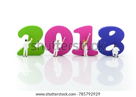 Miniature people: Worker painting wood number 2018 with copy space using as background new year, business concept.