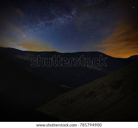 Night starry sky. View of the Milky Way in a mountain valley.