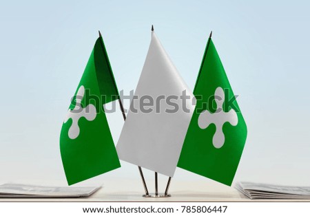 Two flags of Lombardy with a white flag in the middle