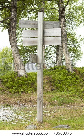 Wooden sign post pointing in several directions