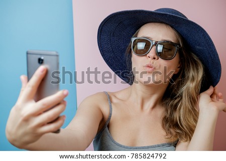 Pretty Young woman in hat and sunglasses with phone. Summer concept