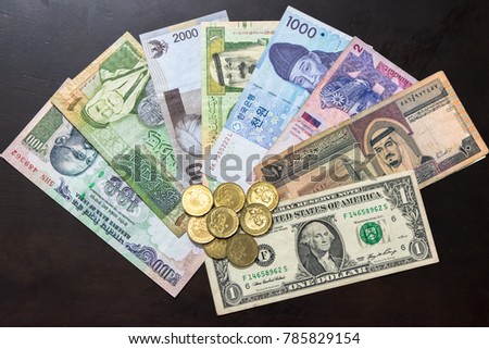 Different international bank notes bills with coins.