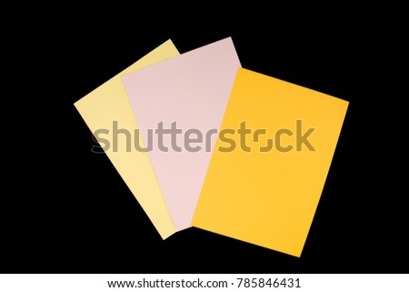 orange, pink and yellow paper isolated on black background