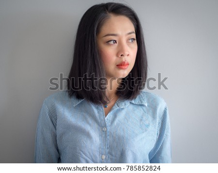 Head shot portrait of Asian woman with big eyes.