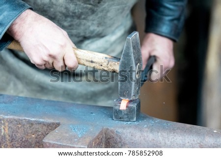 Blacksmith doing smithing in an open forge outdooes