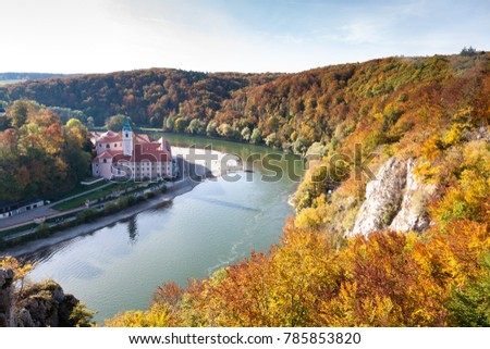 Weltenburg monastery and Donaudurchbruch at the Danube river in Bavaria, Germany surrounded by orange autumn colored trees Royalty-Free Stock Photo #785853820