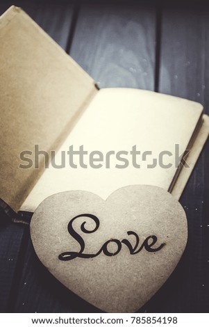 Retro notebook with wooden heart. The inscription "Love"
