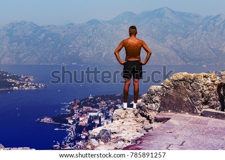Montenegro tourists admire the view of the Bay, houses with red roofs