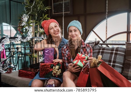 multiethnic diverse group of happy young teenager celebrating Christmas party with champagne
and give gift together, group of friend having fun at New Year's Eve Party 2018, soft focus background