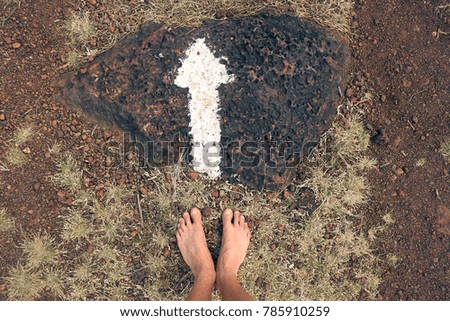 man feet following white arrow