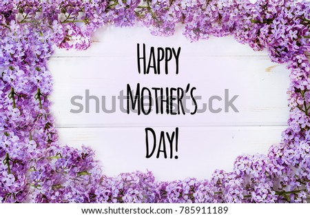 Happy Mother's Day Text with Lilac on White Rustic Wooden Background. Greeting Card Concept. 