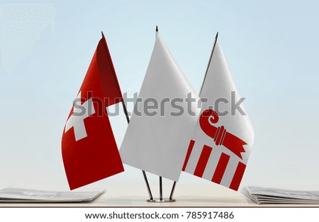 Flags of Switzerland and Canton of Jura with a white flag in the middle