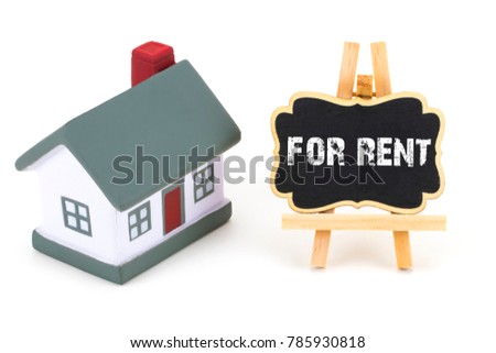 Miniature model of house and a Blackboard with text: house for rent.