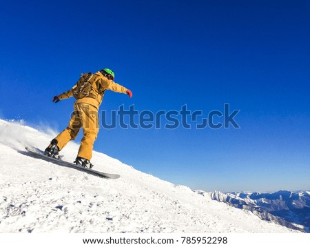 Snowboarder freerider in high mountains