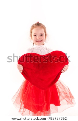 Cute little girl holding red heart isolated. St Valentine's holiday, love and happiness concept.