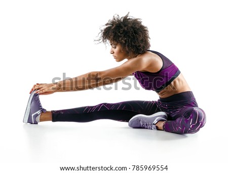 Sporty girl stretching her hamstrings. Photo of african girl doing exercising on white background. Sports Royalty-Free Stock Photo #785969554