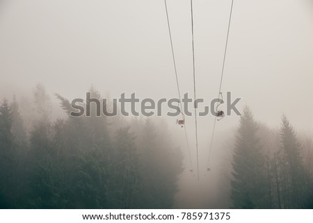 Old ski-lift in misty weather