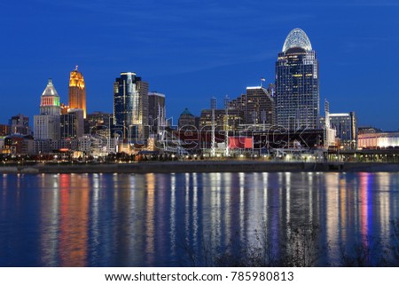 The Cincinnati skyline after dark with reflections