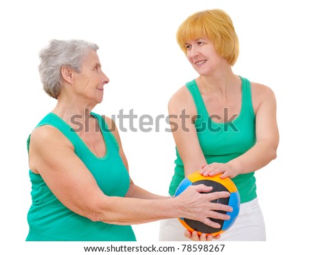 daughter and mother doing gymnastics with ball on white background