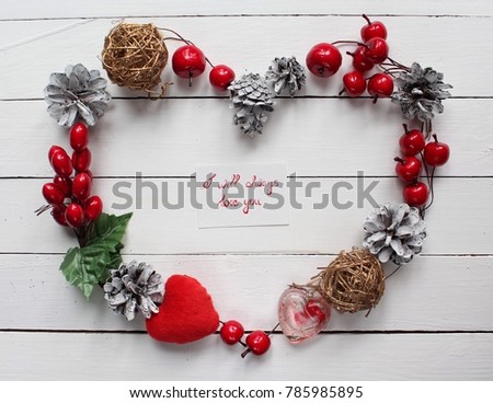 the elements are arranged in the form of a heart, flat lay. a little card in the middle of the picture. I will always love you. concept of Valentines Day. white wooden background for holidays