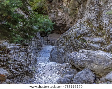 The trail narrows in the Imbros Gorge near Chania, Crete on a bright sunny day