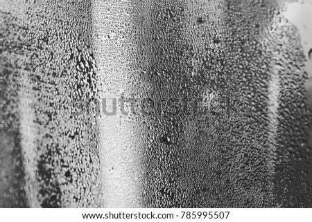 High humidity and condensation in the drops of natural water on the window, temperature drop, cold tone can be used as a background or texture