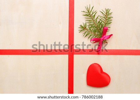 heart and red ribbon with Christmas tree bush