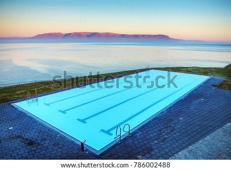 Iceland pool on rock against beautiful sun set.