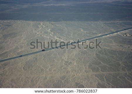 Aerial picture of the Road with truck crossing the Nazca lines, Peru