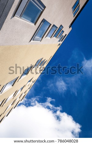 Building walls with windows on blue sky background. Outside