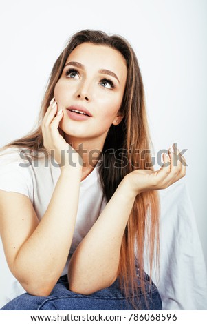 young pretty teenage girl posing cheerful happy smiling on white background, lifestyle people concept